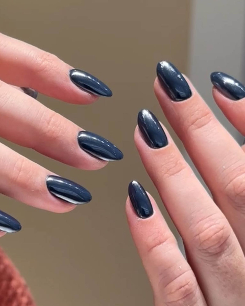 Charcoalcolored metallic nails displayed upwards.